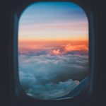 plane window overlooking sea of clouds