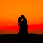 silhouette of man and woman during sunset
