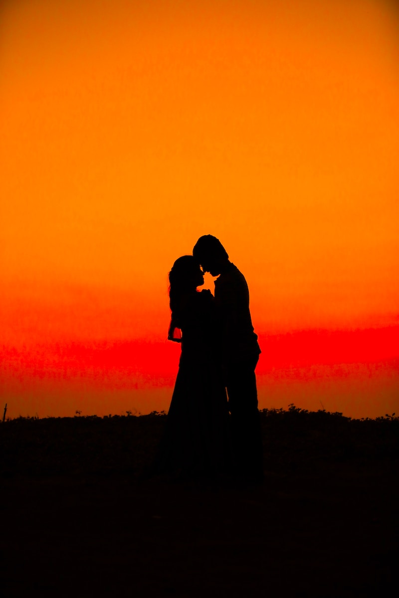 silhouette of man and woman during sunset