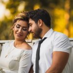 man in white dress shirt hugging woman in white dress