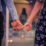 man and woman holding hands